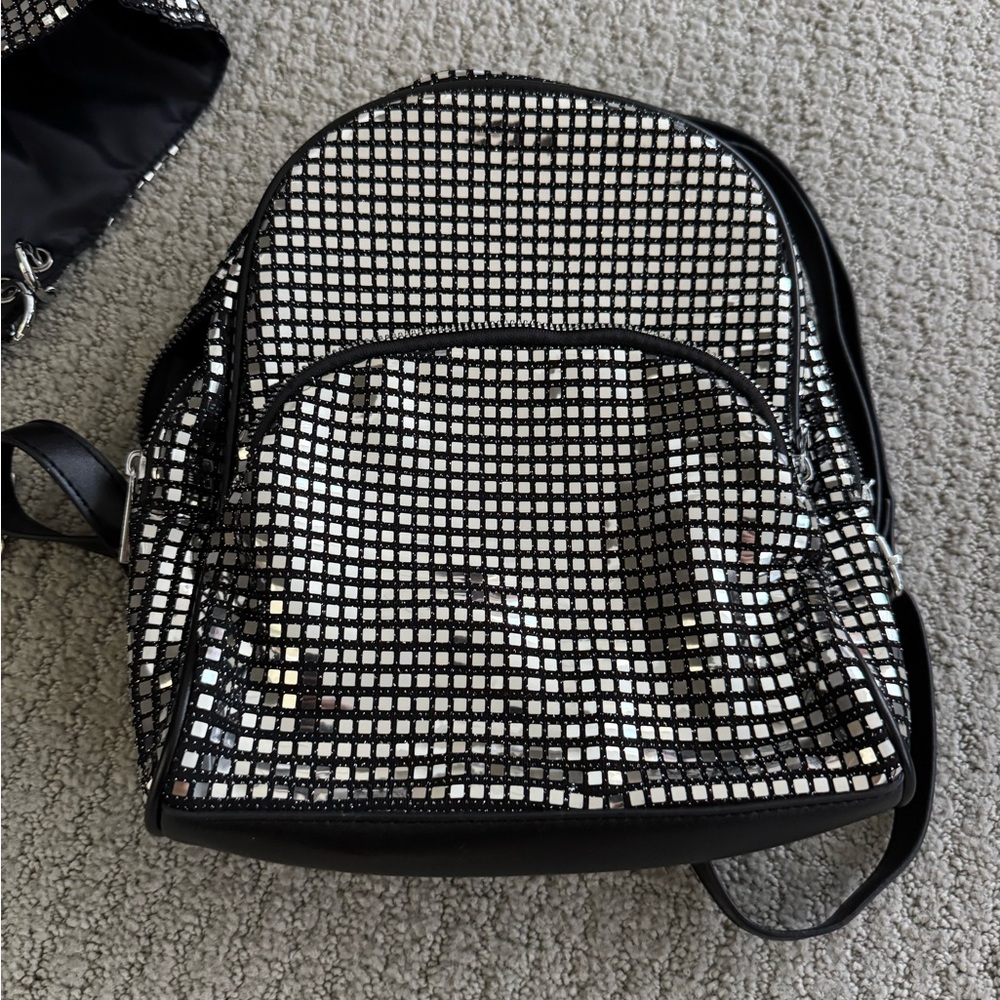 Dolls Kill Silver Backpack with detachable hood.